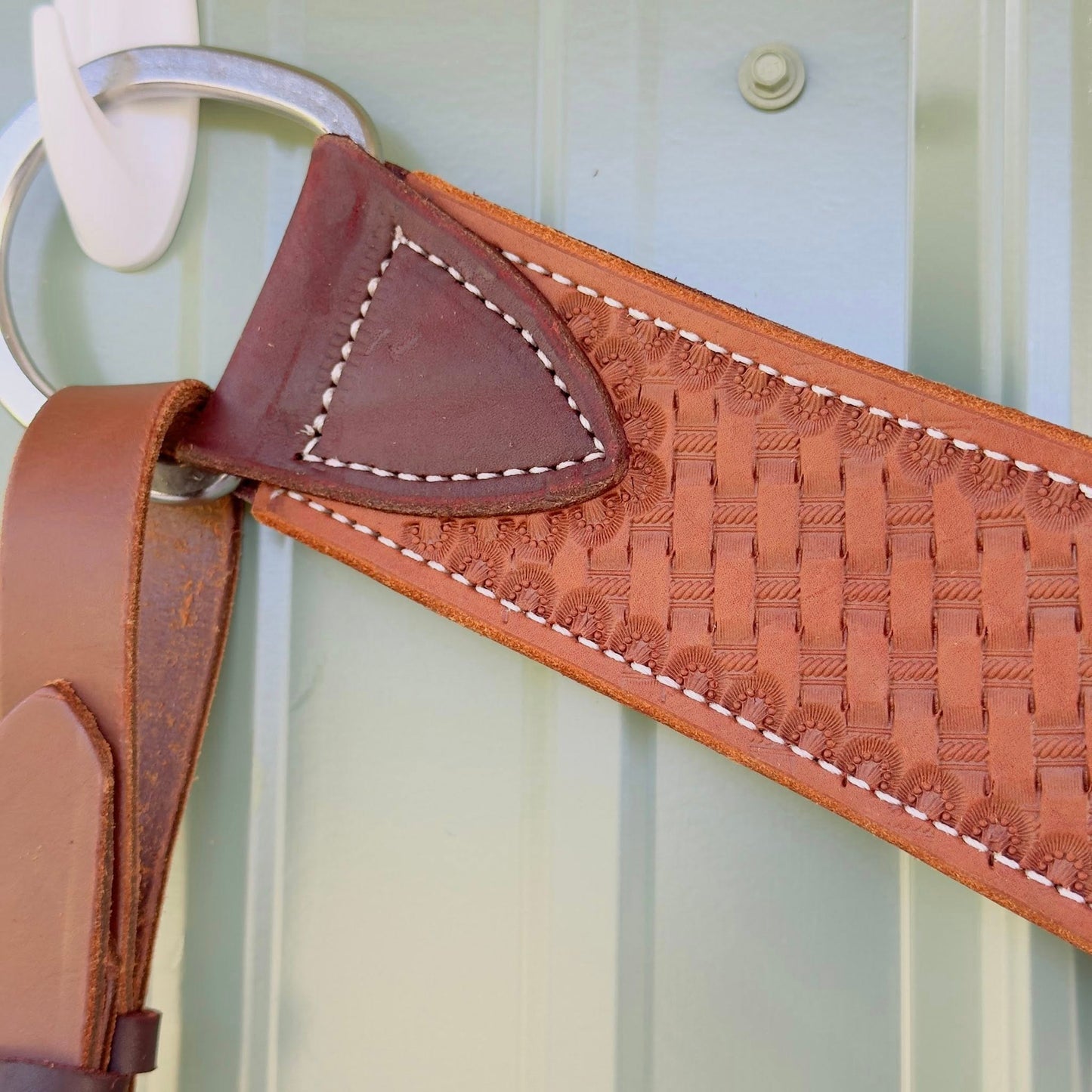 Stainless steel hardware on hand-tooled leather breast collar