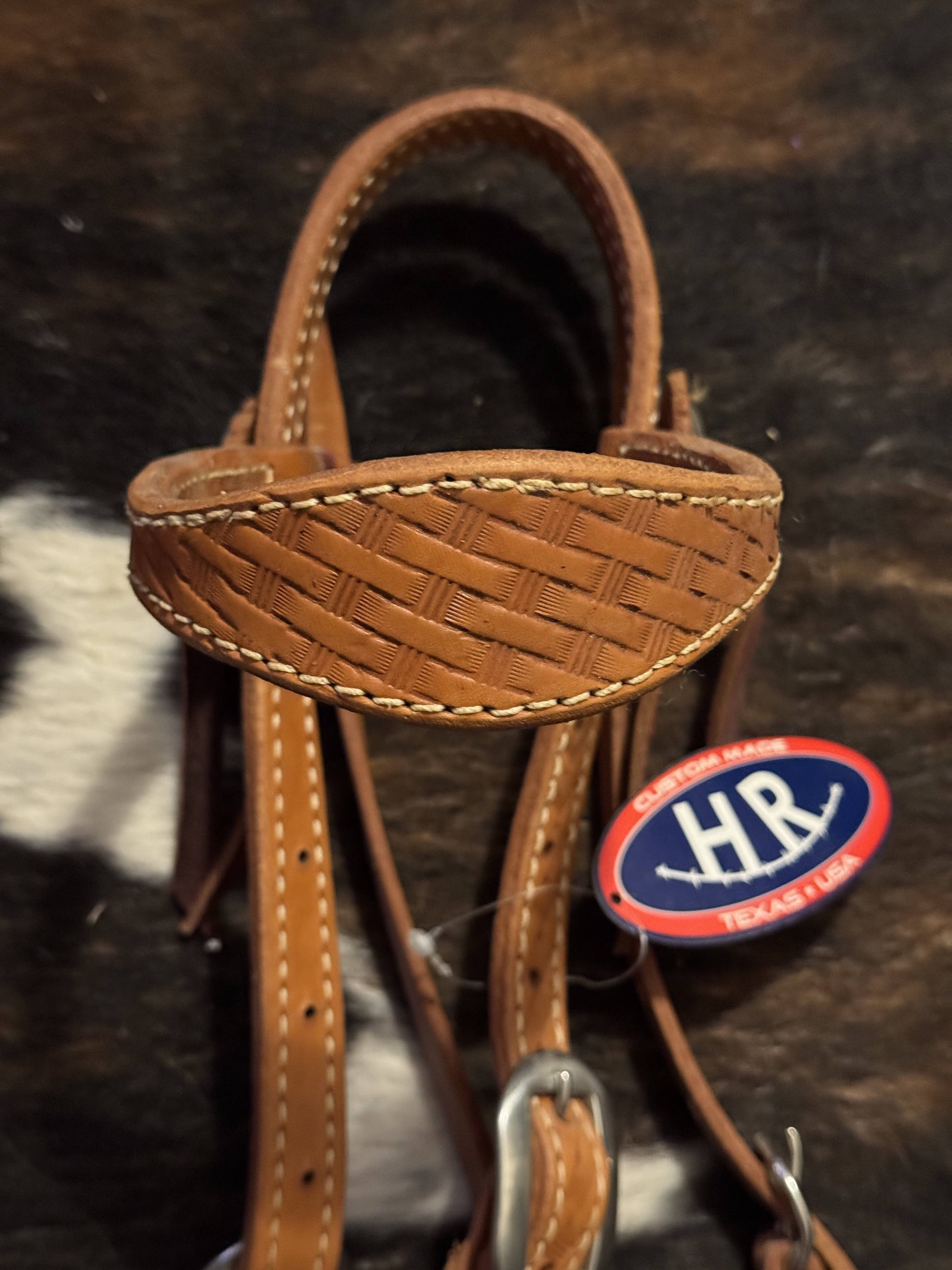 Close-up of basket weave tooling and stainless hardware