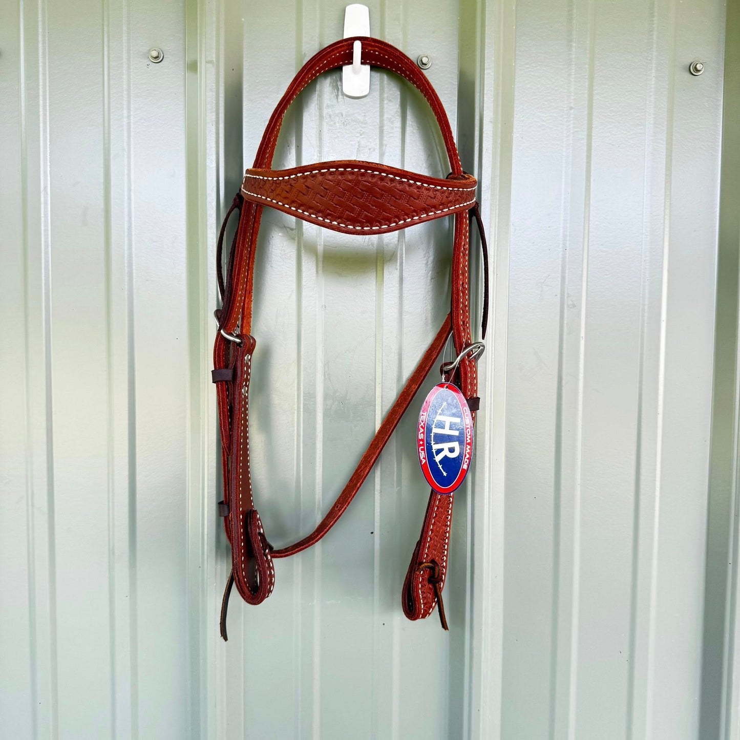 Hand tooled basket weave cowboy headstall with scalloped browband and paddle cheeks
