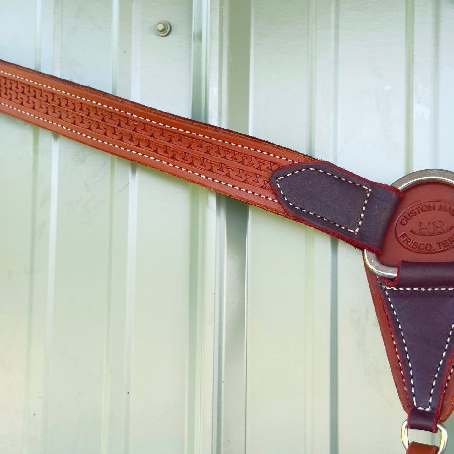 Close-up Running W tooling detail on leather breast collar