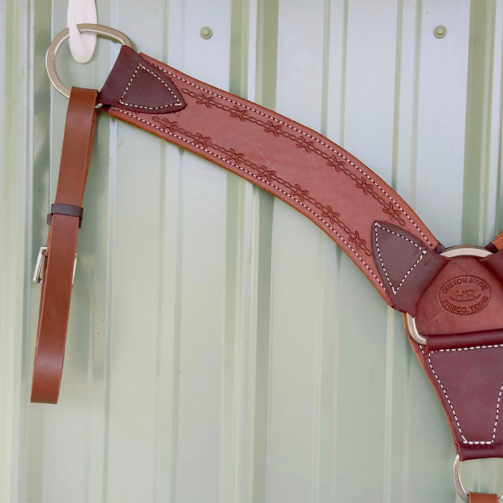 Close-up barbed wire tooling detail on leather breast collar